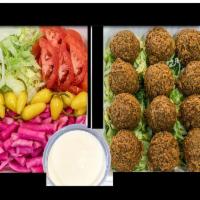 1 Dozen Falafel Pack · 12 pieces falafel served with parsley, lettuce, tomato, pepperoncini, turnip rose pickles, t...