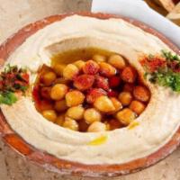 Hummus حـمص · A creamy dip of chickpeas, tahini, lemon, and garlic. Topped with olive oil.
