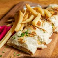 15. Beef Arabi with Fries لحم بيف عربي · Beef shawarma Arabi warped in saj bread. Cut to small bite size pieces and served on a bed o...