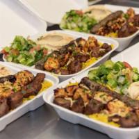 26.Combo Kabab over Rice Plate  · Chicken shawarma, beef kabab, rice, mixed salad, tzatziki, hummus and choice of sauce.