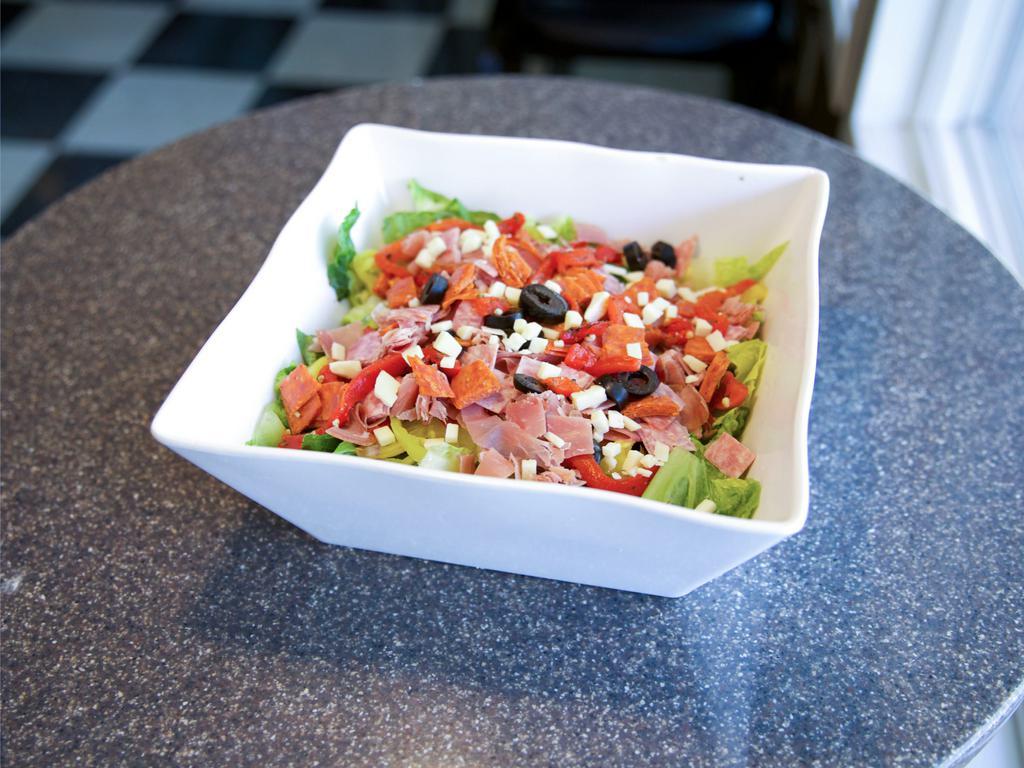 Chopped Italian Salad · Romaine lettuce, prosciutto, Genoa salami, pepperoni, olives, roasted red peppers, hot peppers, extra sharp provolone, house Italian balsamic dressing.