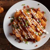 Tots Loaded · Beer cheese sauce, bacon, green onions and sour cream.