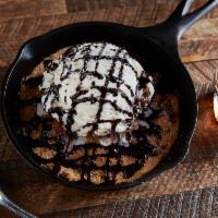 Titled Guilt Chocolate Chip · Hot, fresh baked chocolate chip cookie topped with vanilla ice cream, powdered sugar and cho...