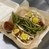 Dos Taco Plate  · Comes with your choice of 2 chicken or pork tacos, topped with slaw, pickles, and BBQ sauce ...