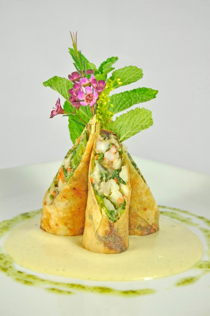 Chilean Sea Bass Spring Roll · Chilean sea bass, scallop, shrimp and vegetable wrapped in crispy spring roll, served with passion fruit and citrus aioli sauce.