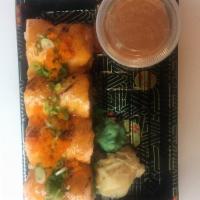 Astoria Roll · Spicy crab meat, avocado and crunch inside, topped with seared salmon, tobiko and chef's spe...