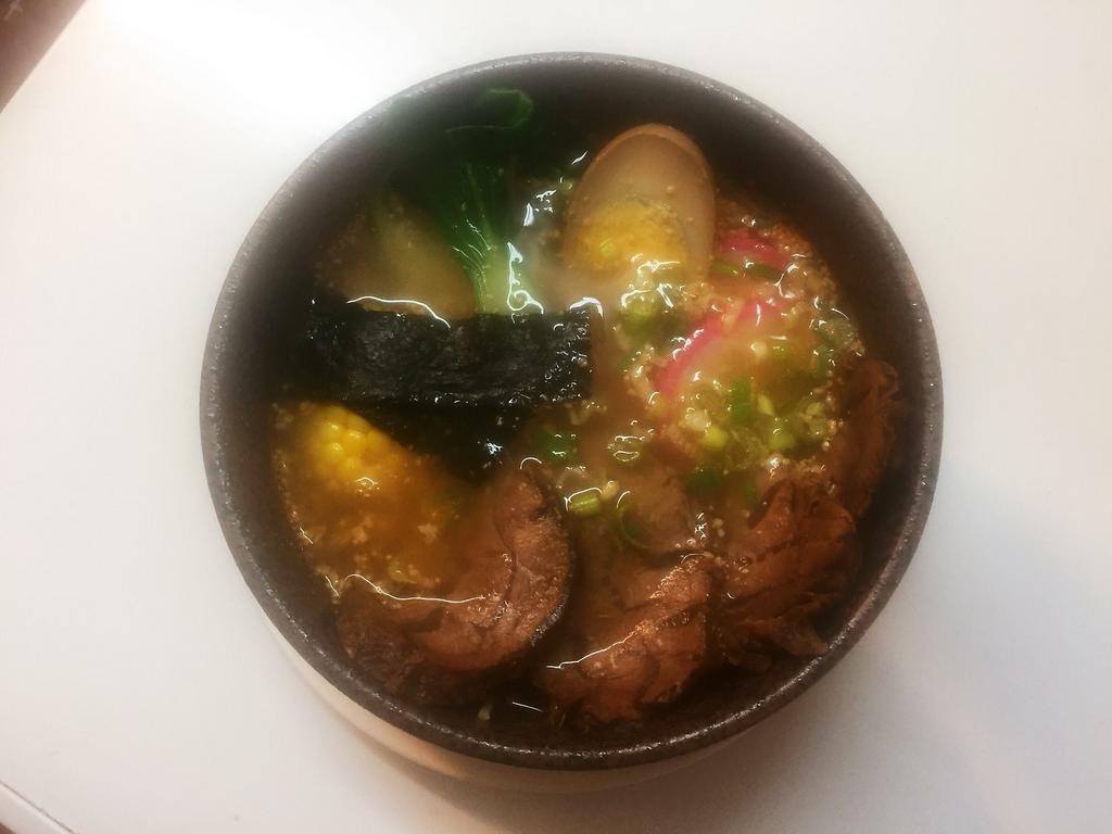 Beef Ramen · Marinated beef. Served with corn, seaweed, bamboo shoot, scallions, naruto fish cakes, enoki mushroom and baby bok choy.