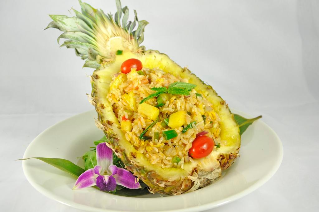 House Special Pineapple Fried Rice · Shrimp, squid, king crab and pineapple fried rice. Served with a side.