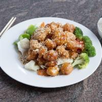 Sesame Chicken Dinner · Crispy light battered chicken covered with sweet sesame sauce on a bed of steamed vegetables