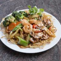 Hong Kong Noodles · Wok-fried noodles topped with shrimp, chicken, beef and vegetables in a brown sauce.
