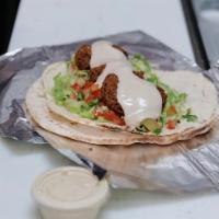 Falafel Wrap · Lettuce, tomato, pickles and tahini sauce wrapped in pita bread. Served with your choice of ...