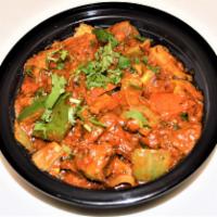 42. Goat Karahi · Goat cooked with green peppers, onions, tomatoes, ginger, garlic and coriander. Served with ...