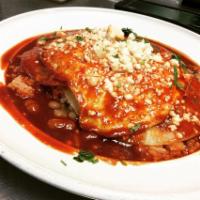 Huevos Rancheros · 2 over medium eggs smothered in homemade red or green salsa served with rice and beans.