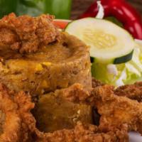 Pollo / Chicken Mofongo  · Fried chicken breast mashed into green plantains with garlic, olive oil, and other seasonings.