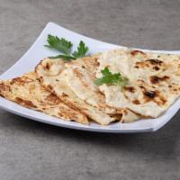 35. Butter Naan · Traditionally baked bread in the clay oven.