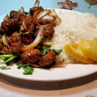 72. Com Bo Luc Lac Sauteed Beef cubes on white rice and onion · 