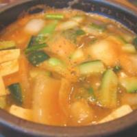 72. Soy Bean Jjigae · Tofu and vegetables in soy bean soup. Choice of the meat.