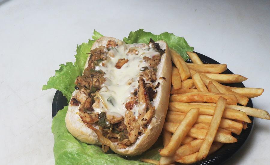 #6 Chicken Philly Cheesesteak · Generous slices of marinated beef grilled with fresh bell pepper, onion, mushrooms and topped with melted mozzarella and mayo on a hoagie bun.