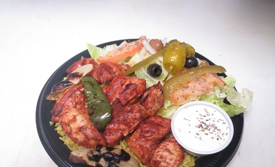 #18 Chicken Shish Kabob Plate · Marinated chicken served on bed of rice, topped with grilled onions, grilled green pepper, salad with pita bread and cucumber sauce.