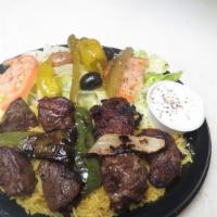 #19 Lamb Shish Kabob · Grilled marinated lamb served on a bed of rice, topped with grilled onions, grilled green pe...