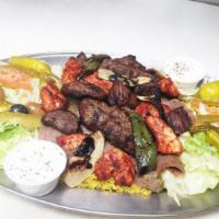 #22 Jawad Grill Combo · Chicken shish kabob, lamb shish kabob and kufta shish kabob on a bed of rice with grilled on...
