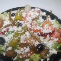 #35 Greek Salad · lettuce, fresh tomatoes onions, olives, cucumbers, sprinkled feta cheese with oregano and Gr...