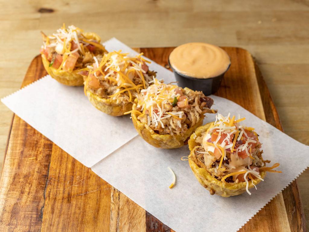 Pernil Mofonguitos · Roasted pork 4) plantains cups with garlic sauce topped with pico de gallo, mixed shredded cheese.