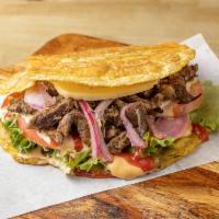 Bistec Patacones · Grilled Steak Fried Green Plantain sandwich with Grilled Cheese topped with lettuce, tomato,...