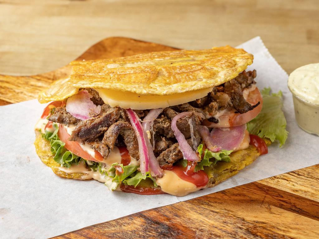 Bistec Patacones · Grilled Steak Fried Green Plantain sandwich with Grilled Cheese topped with lettuce, tomato, our signature Pink mayo, and ketchup.