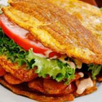 Pernil Patacones · Roasted pork Fried Green Plantain sandwich with Grilled Cheese topped with lettuce, tomato, ...