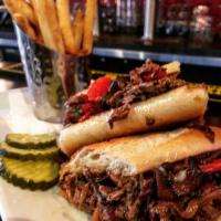 Steak Bomb Sandwich · Shaved rib eye steak with provolone cheese sauce, sauteed mushrooms, peppers, onions, and ga...