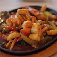 Seafood Hot Plate · An array of bay scallops, shrimp, crab and squid and a scattering of vegetables bathed in sp...