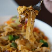 Pad Kee Mao · Soft flat rice noodles sauteed with choice of meat, broccoli, and egg in sweet basil chilli ...