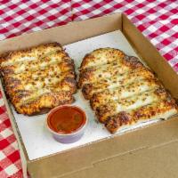 Cheese Dough Stix (12pc) · Freshly baked bread topped with mozzarella, butter, garlic & parmesan romano. Served with pi...