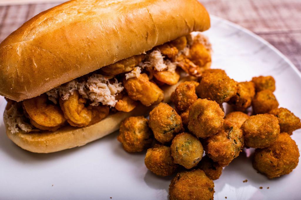 Skrimp and Crabmeat Po'Boy · 13 skrimps covered with blue crabmeat served on a toasted hoagie roll with your choice of our signature spicy or mild skrimp shack sauce.