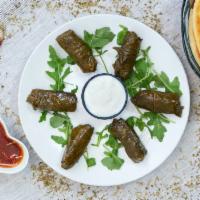 Stuffed Grape Leaves (Dolmas) · Grape leaves stuffed with rice and flavorful herbs. Served with yogurt.  Comes with a pita b...