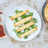 Cheese Rolls (4 Pieces) · Hot and flaky phyllo pastries filled with feta cheese, dill, and parsley. 