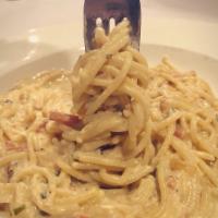 Spaghetti Carbonara · Crisp pancetta, caramelized onion creamy egg yolk.