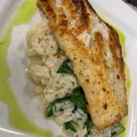 Cod Risotto · On a bed of spinach risotto.