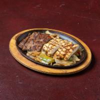 Fajita Platter · Chicken or beef fajita served with frijoles charros, sour cream, cheese, rice, guacamole, pi...