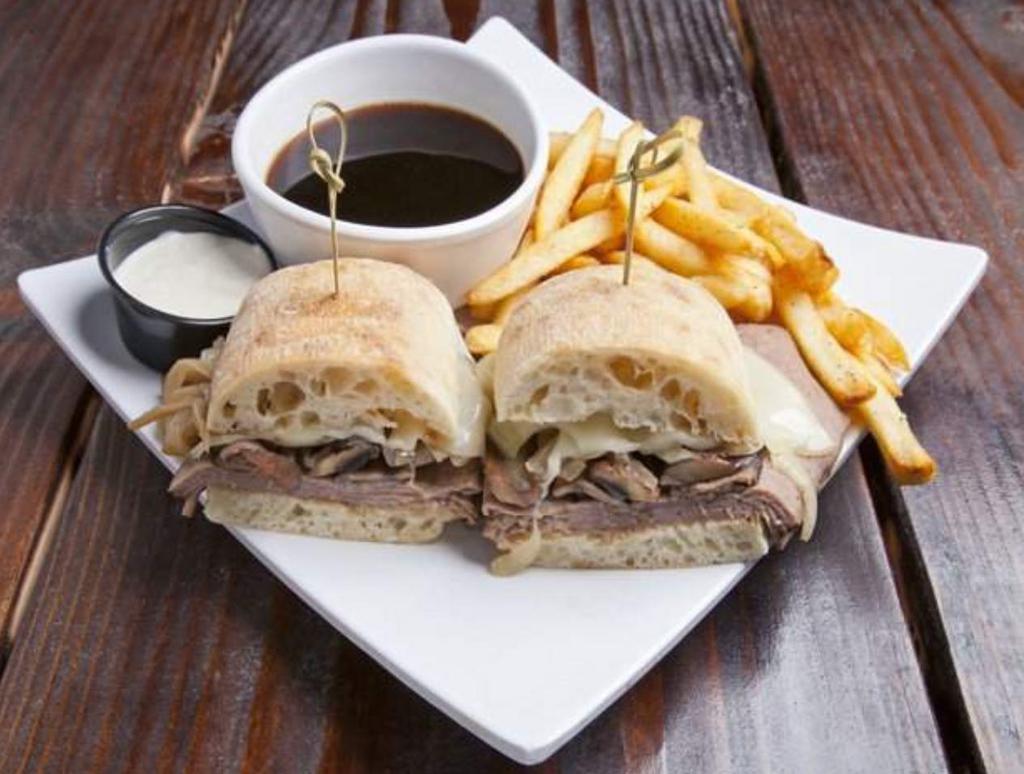 French Dip · Sliced Roast rib, sauteed mushrooms, caramelized onions and Swiss cheese on a ciabatta bread, with a side of horseradish spread and au jus.
