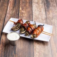 Snake Bite · Jalapenos stuffed with cream cheese, wrapped in bacon and grilled.