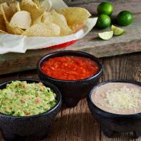 Cuatro · Chips, salsa, guacamole, and refried beans.
