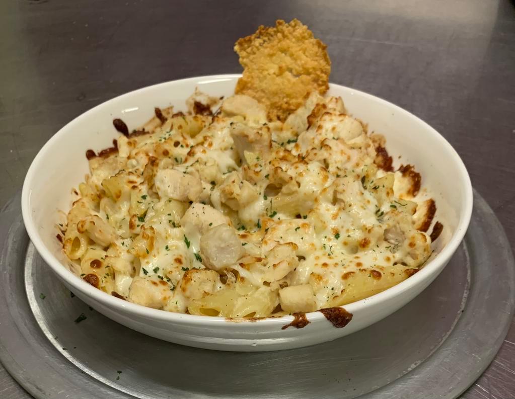 Baked Penne Chicken Alfredo Pasta · Penne pasta baked with chicken, house alfredo sauce, and mozzarella cheese. Topped with Parmesan and parsley. Baked with mozzarella and Parmesan.

