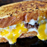 Patty Melt · Fried jalapenos, caramelized onions, pepper jack cheese, cheddar.