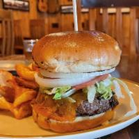 Tejas Burger · Classic Burger. Served with pickles, lettuce, onions, tomatoes, and a side of Steak Fries.