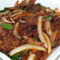 Mongolian Beef 蒙古牛 · Tender beef dry sauteed with green onion, white onion, garlic and dry chili pepper in dark s...