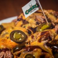 Pork Nachos - Full Order · Crisp tortilla chips topped with pulled pork, BBQ sauce, cheese queso, jalapenos and dry sha...