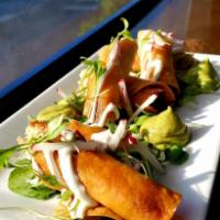 Flautas ahogadas · Crispy Tacos 
Filled with shredded chicken 
Served in salsa roja, white cabbage, crema and Q...