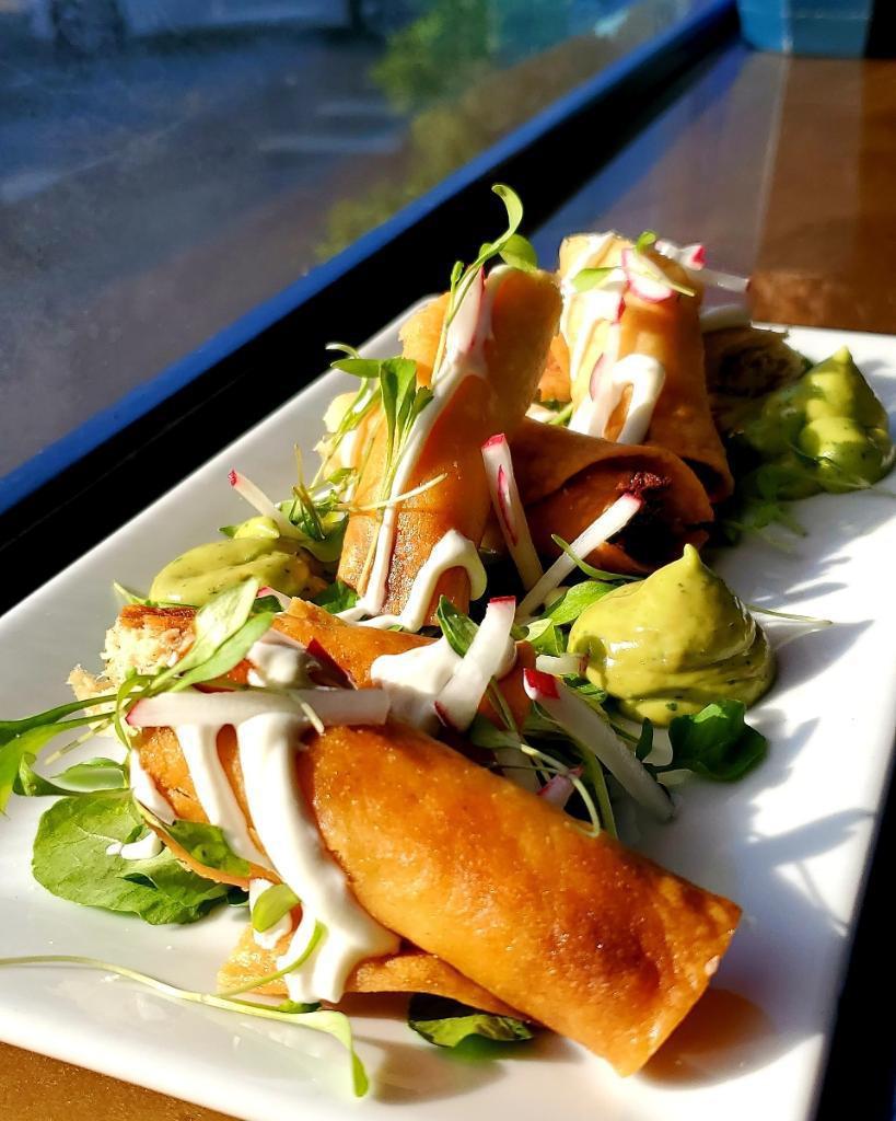 Flautas ahogadas · Crispy Tacos 
Filled with shredded chicken 
Served in salsa roja, white cabbage, crema and Queso Fresco Radishes 







